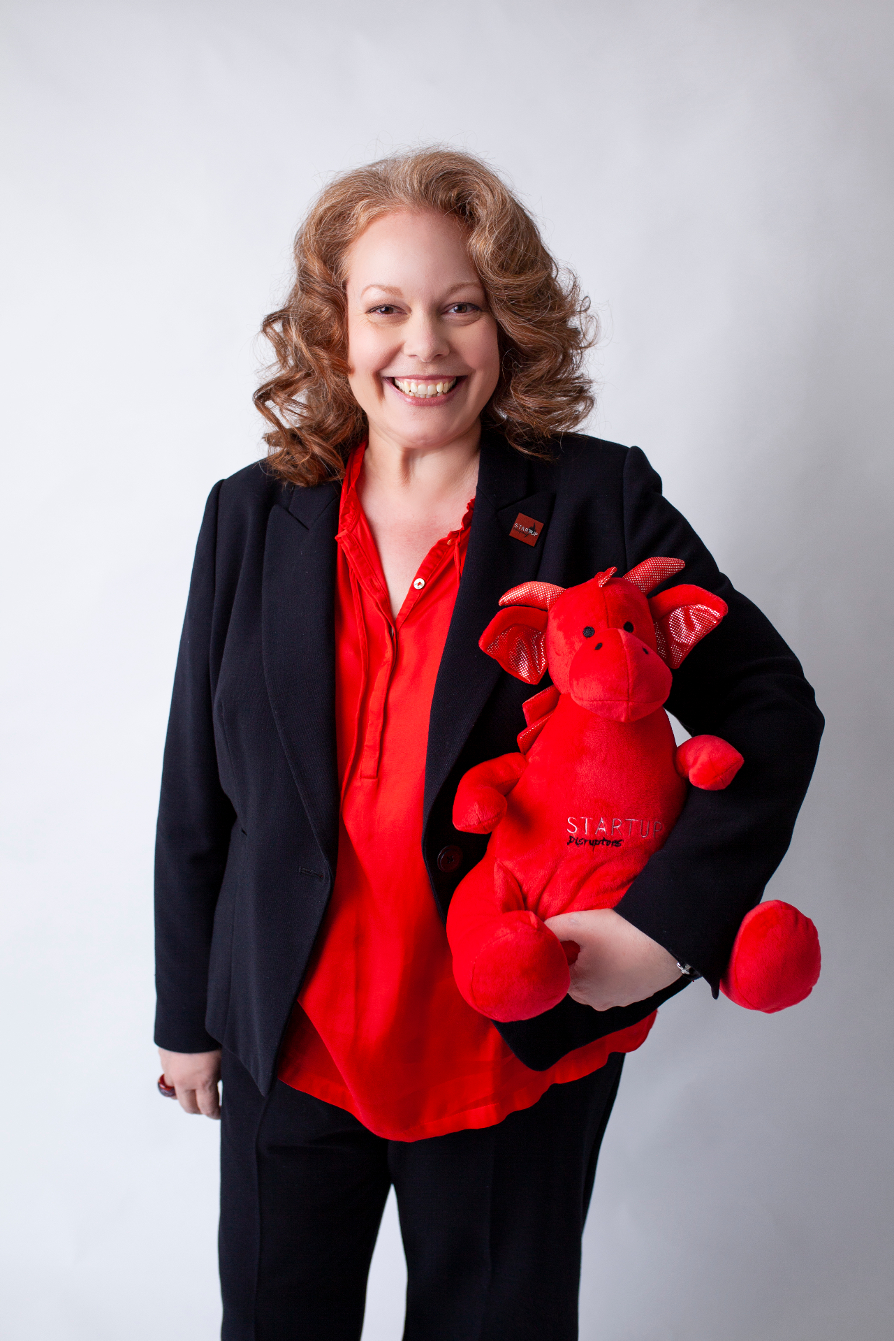 Becky Lodge with the StartUp Disruptors mascot Den the Dragon